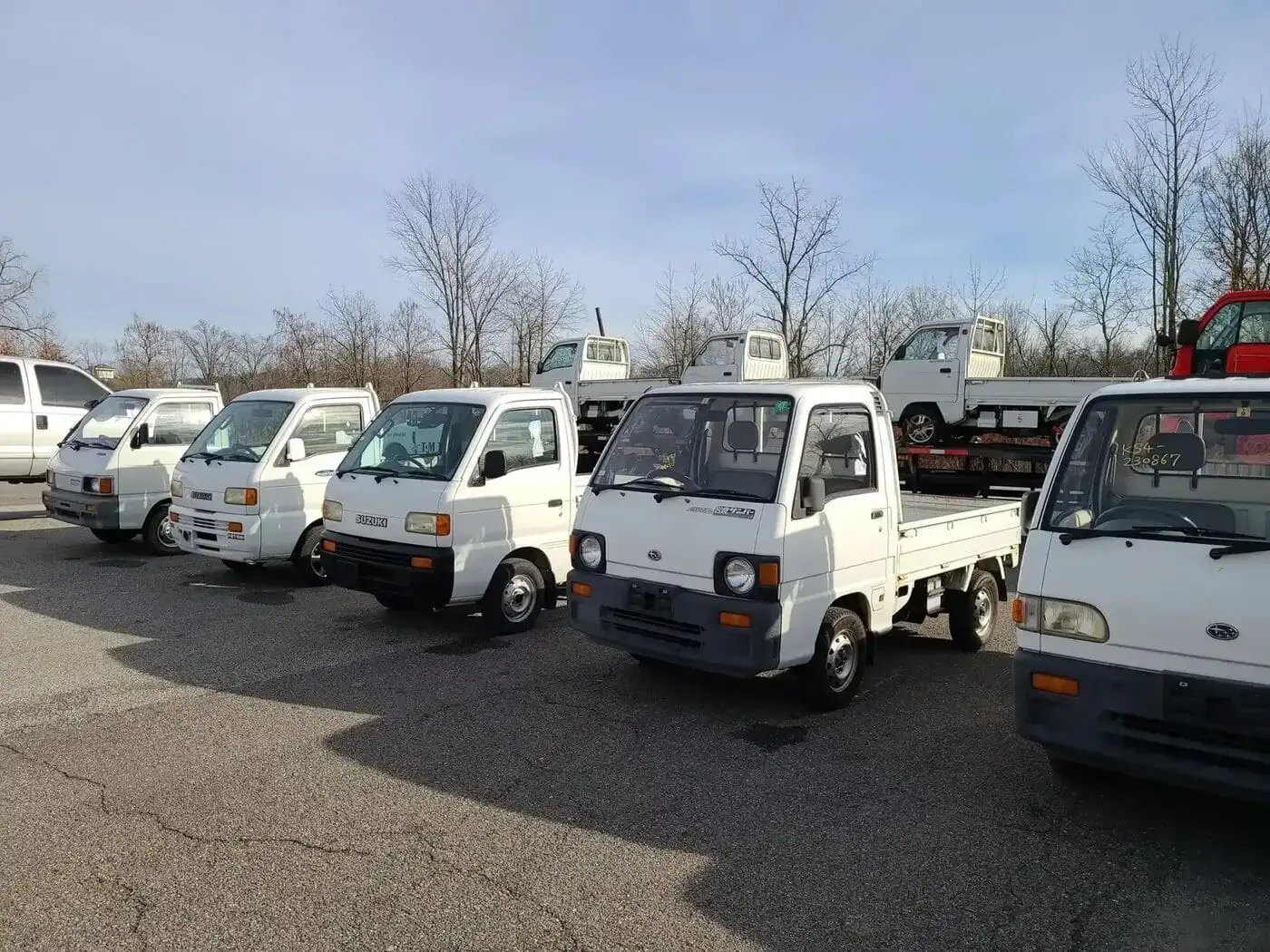 Kei trucks lined up on the Keys Mini Trucks lot in the Texas Hill Country